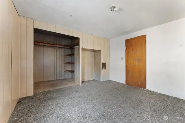 Bedroom with large closet and a smaller storage area