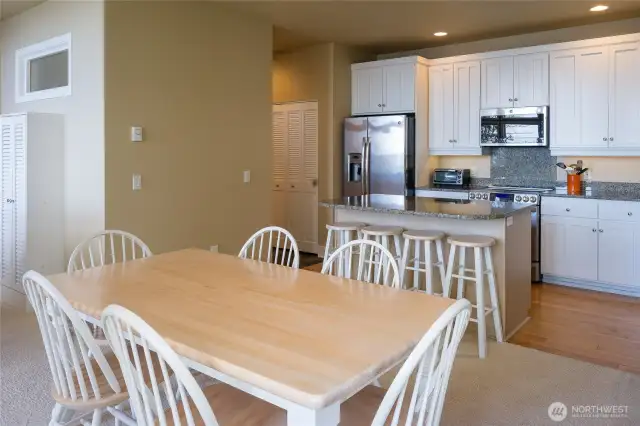 Hallway leads to half-bath and attached two-car garage. Hall closest contains washer and dryer.