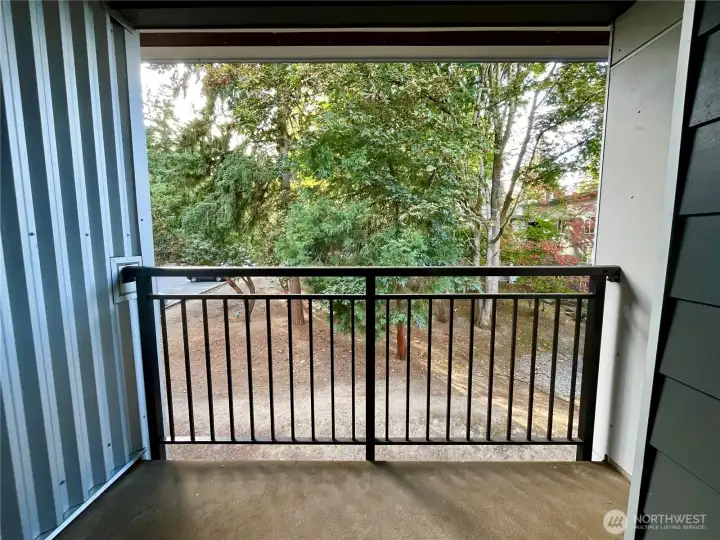 Balcony overlooks wooded area