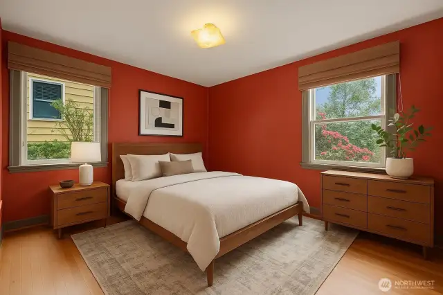 This is a virtually staged image of one of 2 bedrooms that enjoy oak hardwood flooring. The newer windows face north and east.