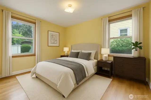 The back (west) bedroom has newer windows that face north and west. Like the other bedroom, it also offers oak hardwood flooring. And like the other bedroom images, this one is virtually staged to give you suggestions for furniture placement.