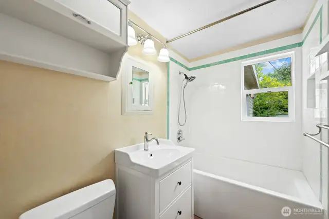 EVERYTHING in the bathroom has been tastefully updated and the tub features a tiled surround. Although not shown in this photo, the oak hardwood flooring is beautiful!