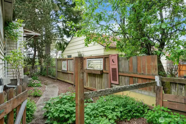 Reclaimed vintage windows add character to the south side fencing.