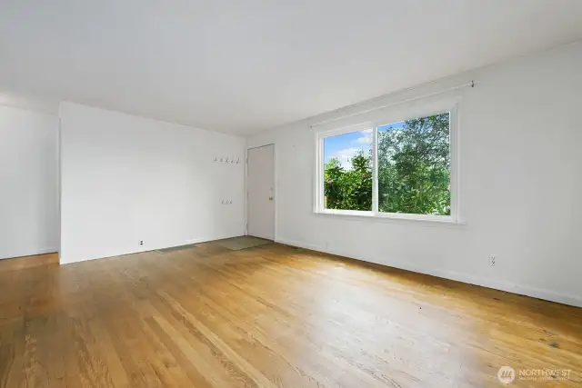 The living room has beautiful 1944 oak hardwood flooring that needs to be refinished back to its original glory, but the quality of the wood is grand.