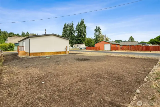 The freshly planted lawn adds vibrant curb appeal, while two newly installed gravel parking spaces offer practical convenience.