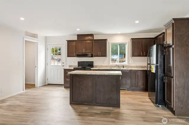 There is a laundry room to the left of the kitchen.