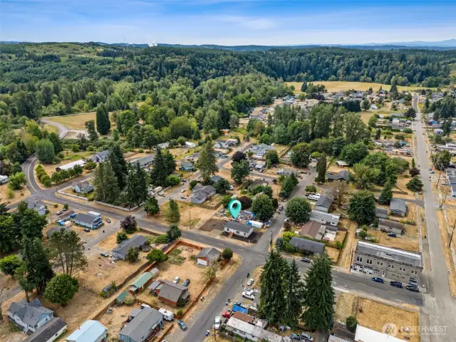 Captured from above, this aerial view showcases a pristine 2025 manufactured home situated on a tidy, well-maintained lot. The home features a modern, energy-efficient design with a clean roofline, contemporary siding, and a spacious layout.