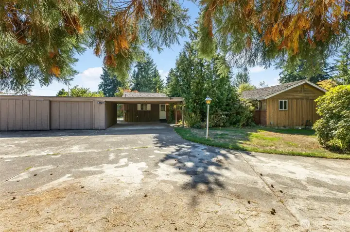 Covered parking for 2 under carport, enclosed shop with room for 1 car possible. RV parking and additional driveway parking
