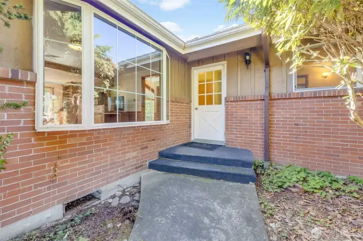 Home features brick and cedar siding which welcomes you into the main door of home