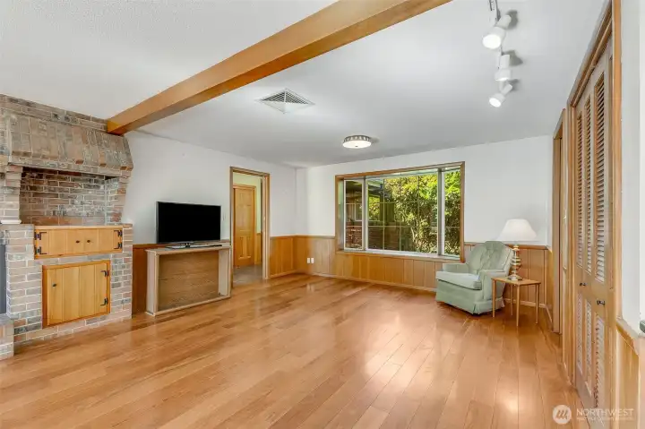 Family room has great lighting, beams and bench seats. The brick details have an original area for indoor grilling, now converted to a cabinet