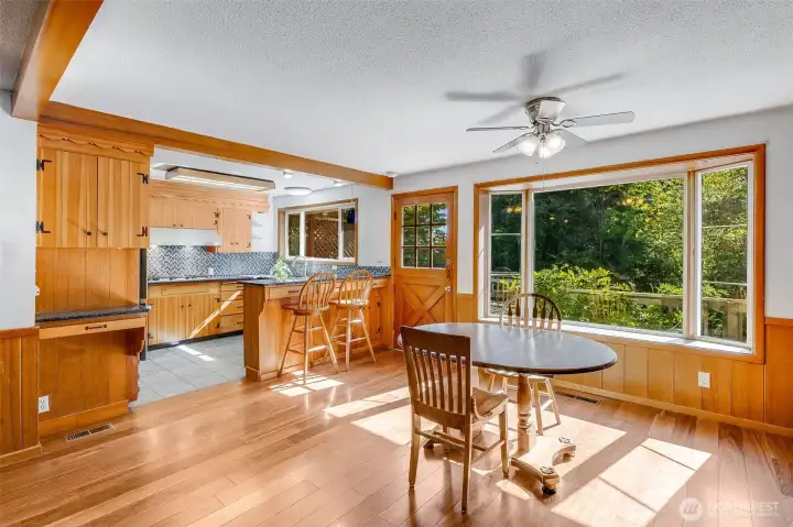 Dinging room area with bay window& ceiling fan