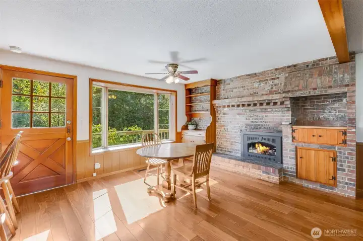 Gas fireplace insert and built-in shelving and cabinet feature in dining area