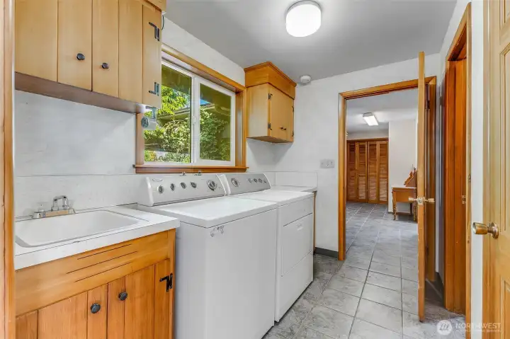 Laundry room with soaking sink connects family room and primary suite