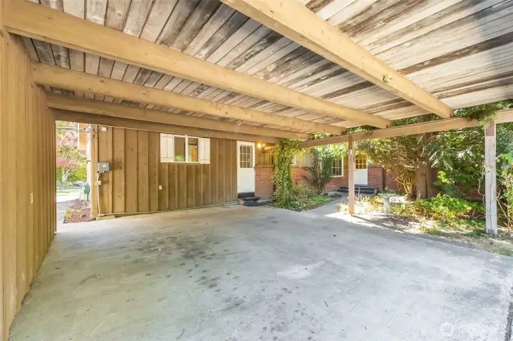 Covered carport had massive beams and white washed details on ceiling