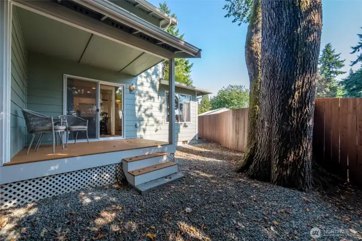 Fully fenced backyard with cozy covered back deck.