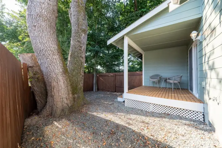 Fully fenced backyard with cozy covered back deck.