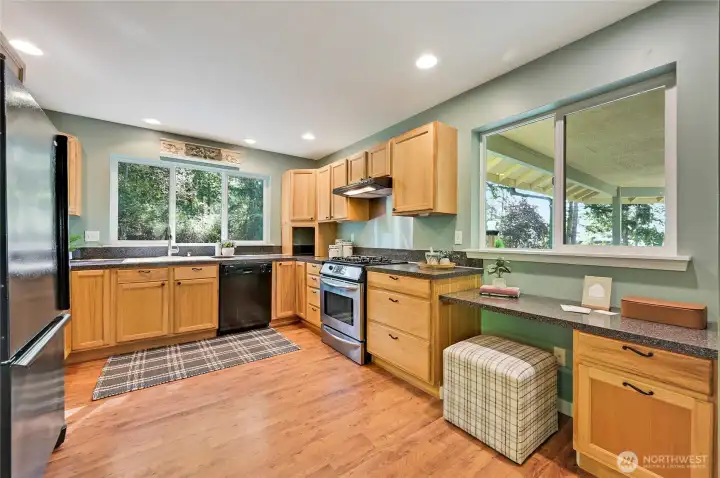 Enjoy peaceful outlooks of evergreens while standing at the kitchen sink. Peak-a-boo water views to the south.