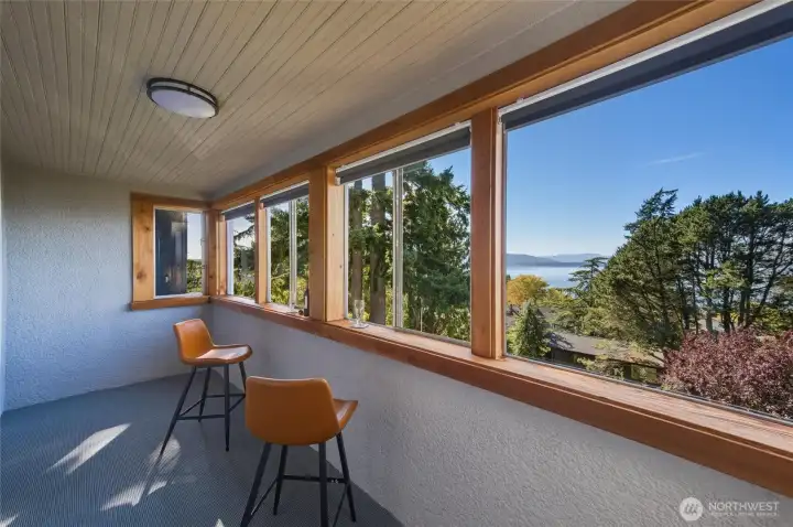 Enclosed bay view balcony, accessed through Unit A main bedroom.