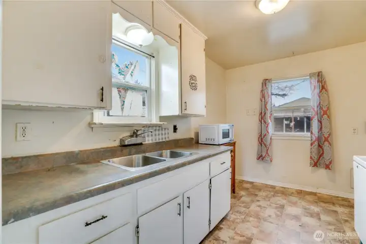A kitchen with an eating nook—ready for a complete refresh.