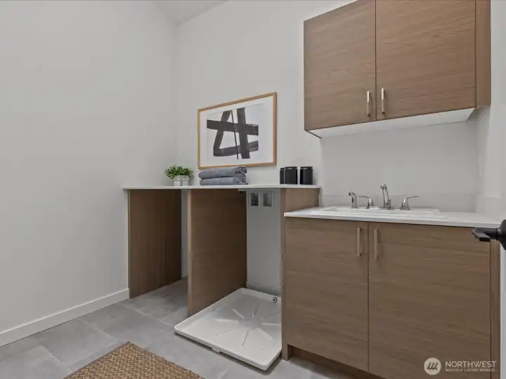 Convenient, dedicated laundry room on the upper level! Model home.