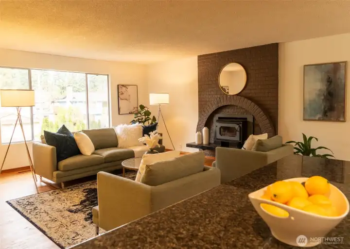 Gather in the cozy, open-concept  living room, while the fireplace insert takes the edge off of winter. Remember how those old split-level kitchens felt so cut off from the rest of the home? The walls here have been removed, the kitchen is opened up, and the space just flows.