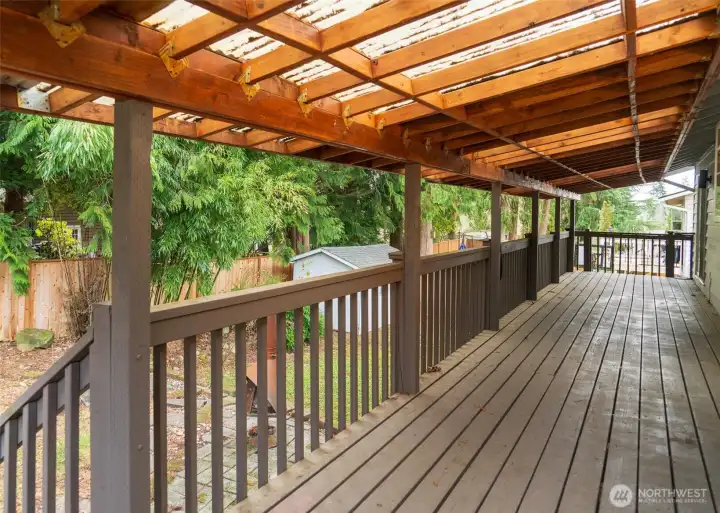 A covered deck overlooks the back yard, with slider access from either the dining room or the main bedroom.