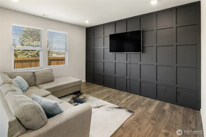 Custom accent wall in the great room and laminate hardwood floors on the main floor.