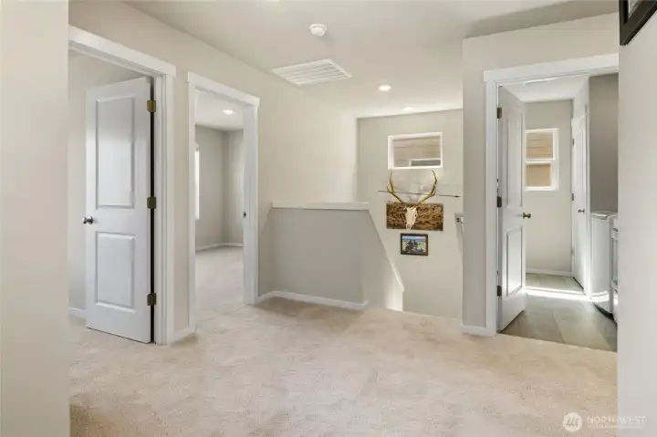 Bedrooms two and three and the laundry room are off the second floor landing.