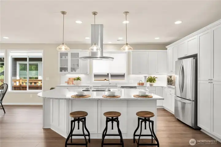 Custom pendant lighting anchor the large island. Custom pendant lighting anchor the large island.