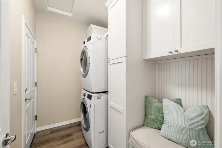 The laundry/mud room with a built-in bench and additional storage. The laundry/mud room with a built-in bench and additional storage.