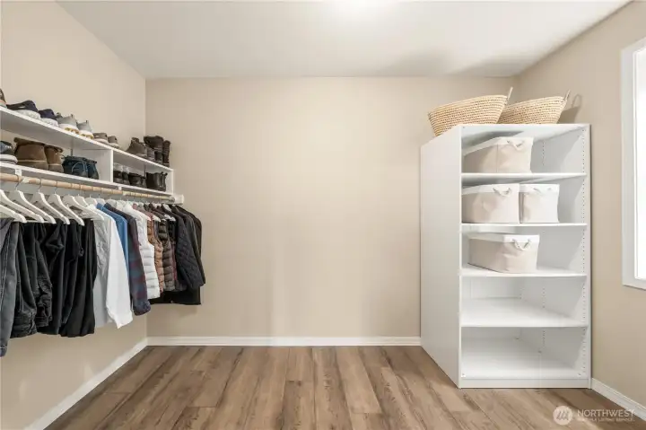 Spacious primary closet. Spacious primary closet.