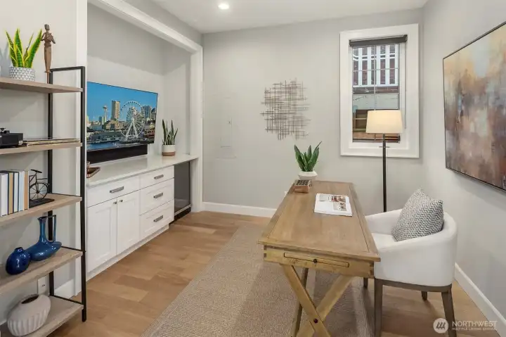 Den is complete with counter, storage and beverage fridge.