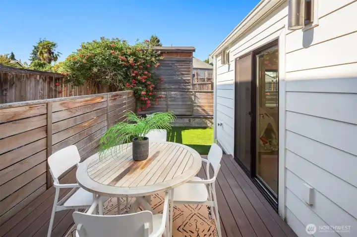 Back deck with access from kitchen or flex space.  Leads to turf backyard and parking.