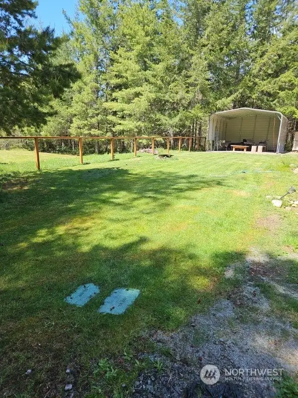 Lush green grass of the well manicured lawn. Access lids to the sprinkler valves in the foreground.