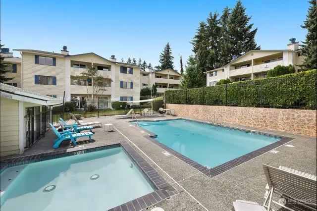 Community features an outdoor pool/hot tub area, athletic courts and surrounded by beautiful tall trees.