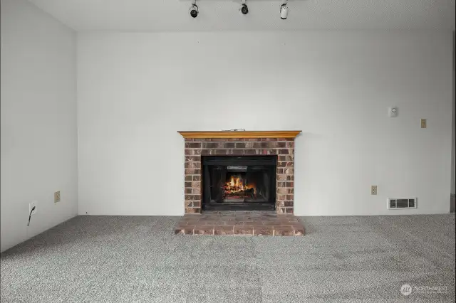 This cozy wood burning fireplace with a classic brick surround offers the perfect ambiance.