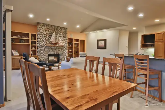 Perspective from the dining area. Your primary suite is to the right of the fireplace and the hallway that leads to the 1/2 bath is to the left of the built-in desk/kitchen.