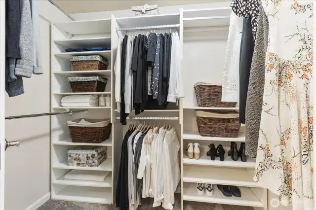 Primary Walk-In Closet with custom shelving.