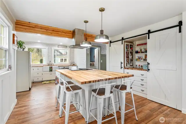 Custom built in storage with dual barn door pantry provides all the storage you'll need in this huge and inviting kitchen.
