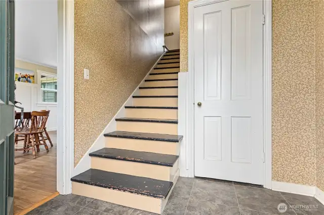 This is the entry from the official front door, which leads to the kitchen on the left or the living room on the right. Deep coat closet pictured here and stairs leading to the bedrooms upstairs.