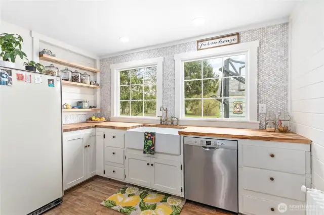 Upcycled kitchen cabinets are original to the home to preserve its authentic farmhouse feel, complimented with a new huge basin sink and modern stainless steel dishwasher.