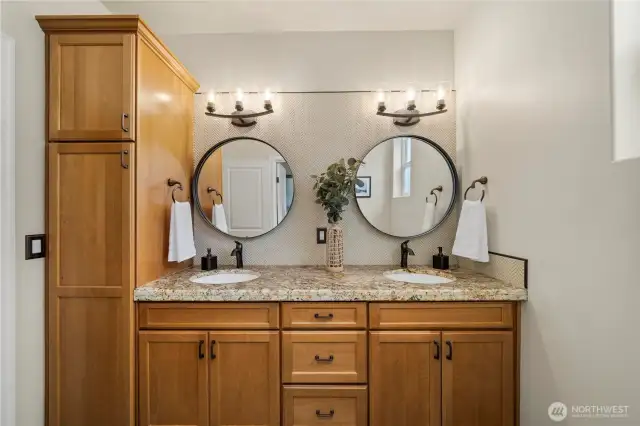 Additional full bathroom with dual sinks and ample cabinetry offer convenience and comfort