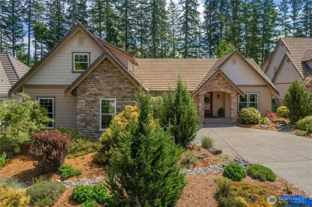 Thoughtful and meticulous landscaping spans the entire property, lush, vibrant, and lovingly maintained by original owners