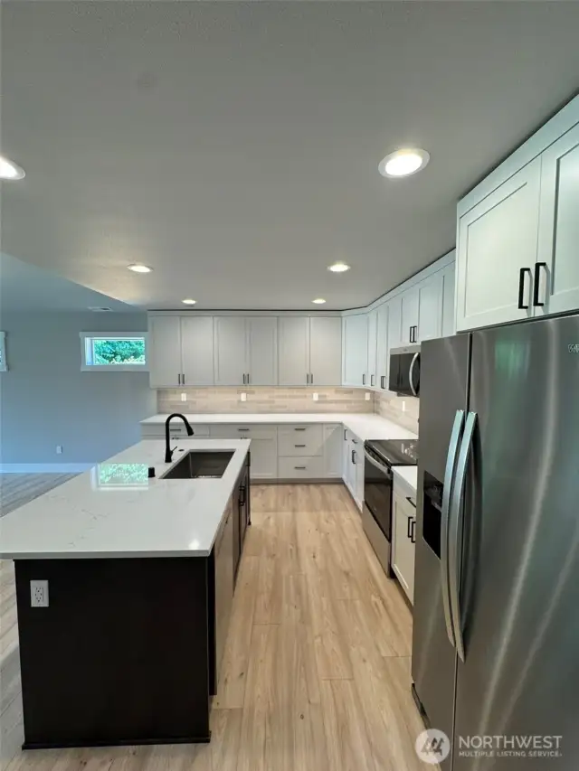 Open concept kitchen with eat-in island bar