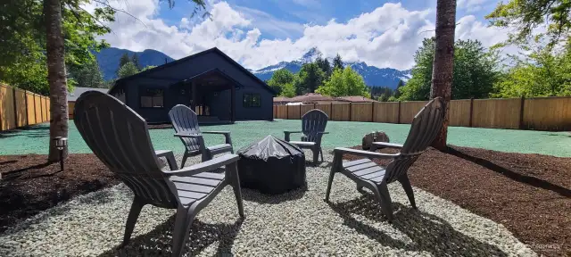 Backyard firepit with views and estate style privacy fence.  Newly hydro-seeded lawn.