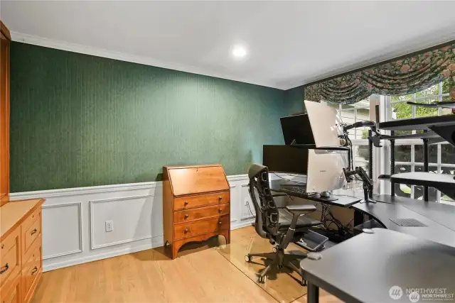 This well-appointed home office offers a quiet and productive workspace with ample natural light streaming through large windows. The neutral tones and modern finishes create a professional yet inviting atmosphere. Thoughtful design elements, including built-in storage and flexible layout options, ensure efficiency while maintaining a comfortable aesthetic. Whether used for remote work, creative projects, or household management, this office space provides both functionality and style in a convenient downstairs location.
