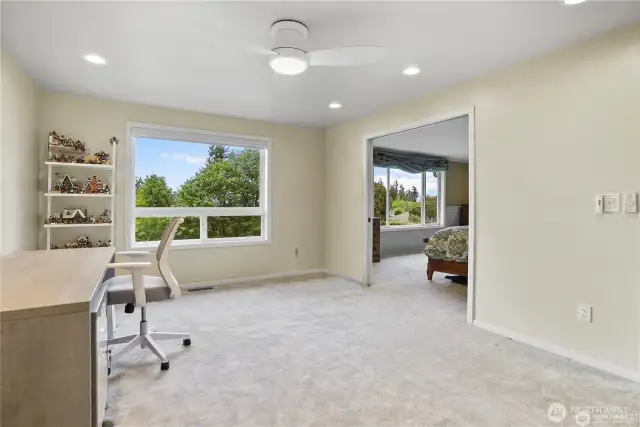 This spacious upstairs loft offers endless possibilities, serving as a comfortable retreat, media room, or home office. Large windows frame breathtaking views of the lush ravine, allowing natural light to fill the space while creating a serene atmosphere. Neutral tones and modern finishes enhance the room’s versatility, while open-concept design ensures seamless flow. Whether used for relaxation, entertainment, or productivity, this bonus area provides both functionality and a stunning backdrop.