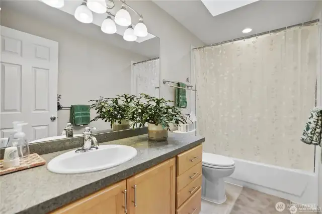 A polished full bath with a sleek vanity and modern lighting, providing both style and functionality.