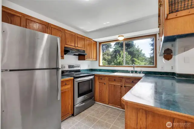 A well-functioning kitchen highlights stainless steel appliances, all included in the sale of the home.