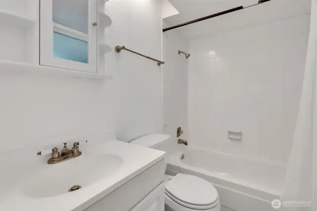 Full bath serving bedrooms two and three on upper level.